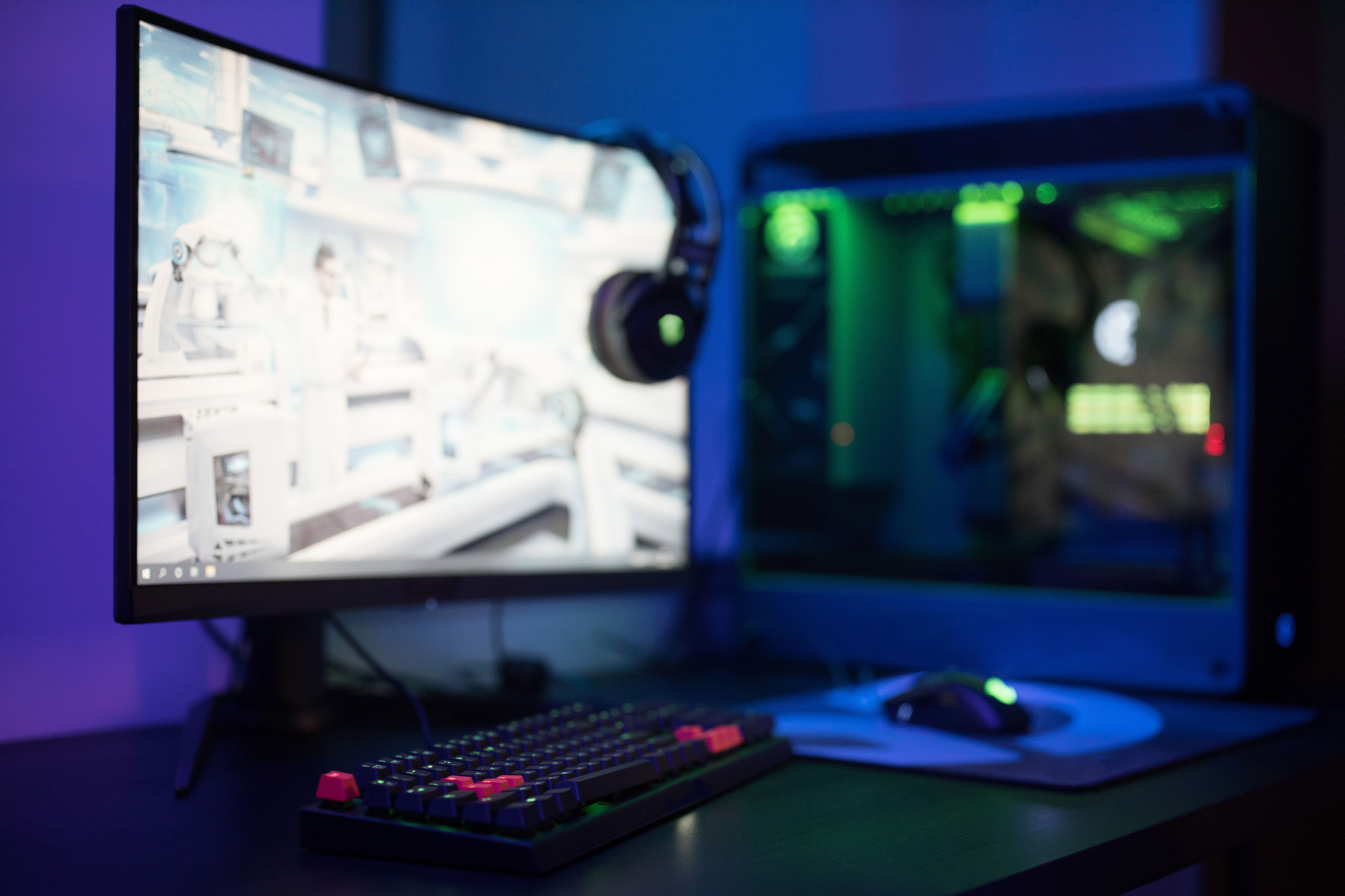 High-tech PC gaming setup with a curved monitor, RGB keyboard and mouse for playing Standoff 2 on PC
