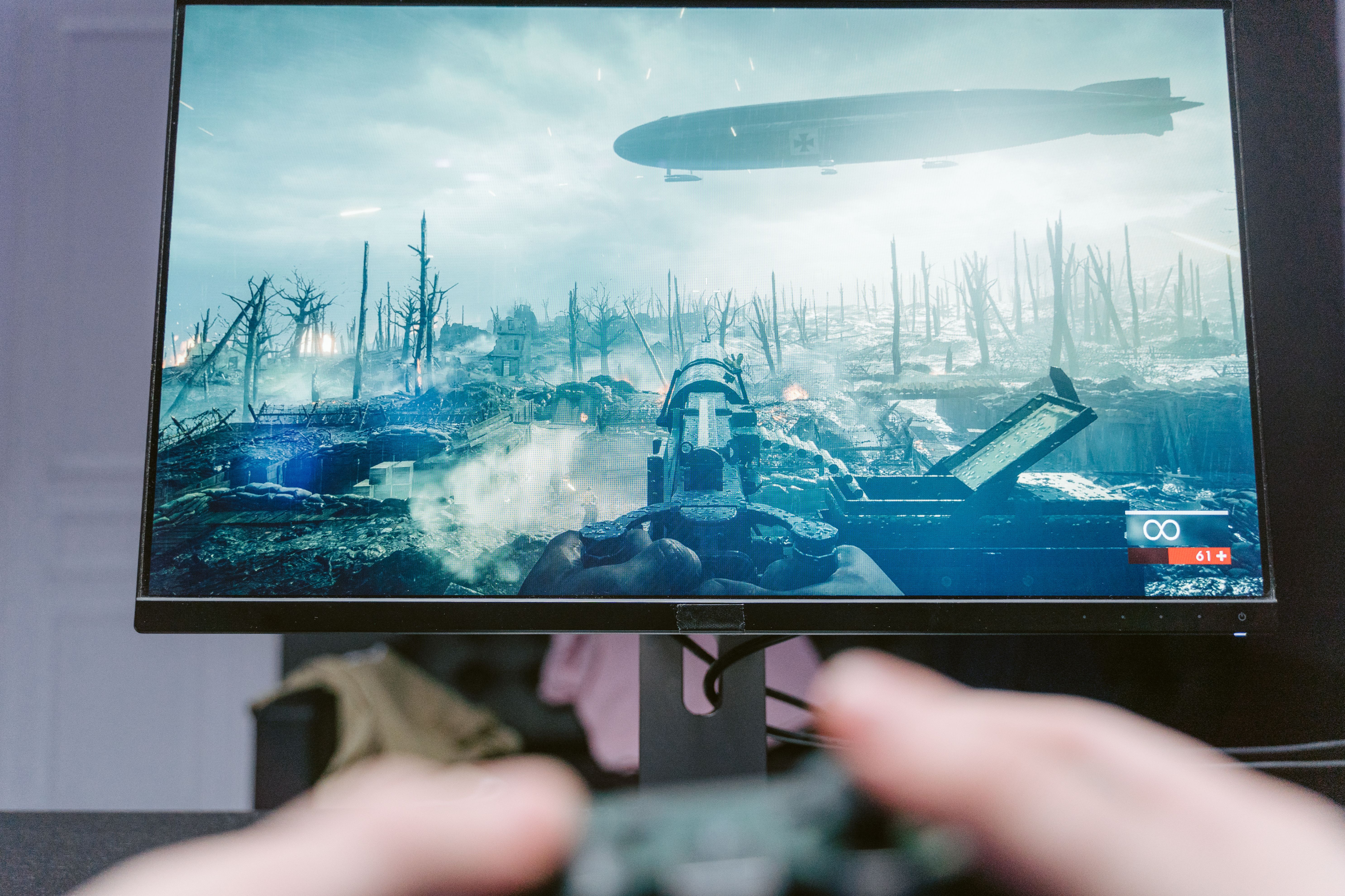 Player viewing a war-themed shooter battleground on a high-resolution PC monitor